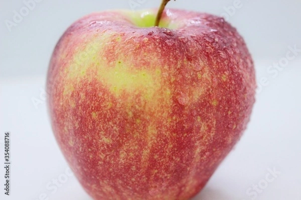 Obraz Beautiful ripe red wet apple is located on a white background