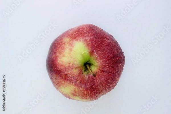 Obraz Beautiful ripe red wet apple is located on a white background