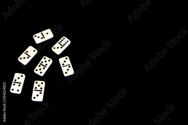 Obraz Dominoes on a black background.
