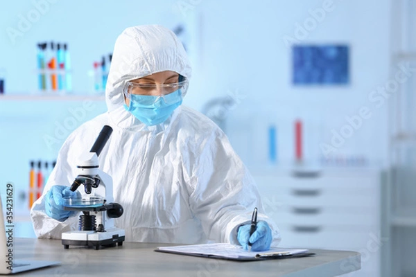 Fototapeta Scientist working with microscope in laboratory