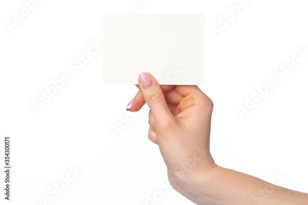 Fototapeta Woman's hand with blank white business card isolated on white