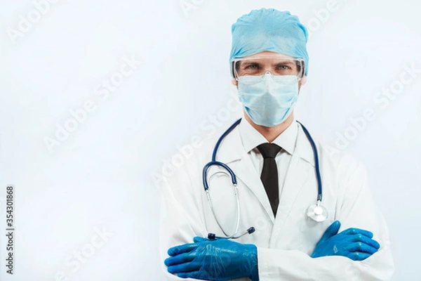 Fototapeta close up. serious paramedic in a protective mask looking at you.