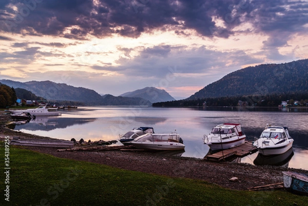 Fototapeta Lake shore with moored motor boats at dawn. Teletskoye Lake, Artybash Village, Altai Republic, Russia