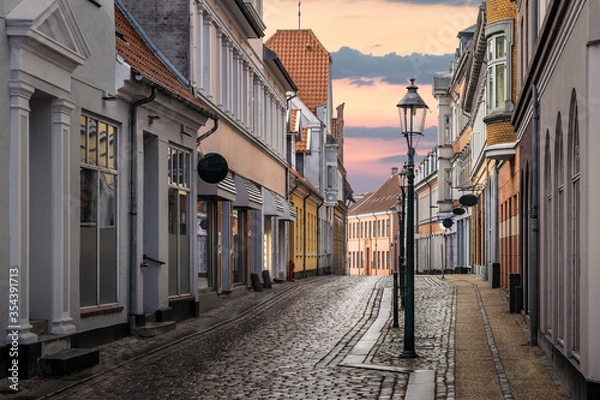 Fototapeta A beautiful colorful street at sunset in Viborg, Denmark. Beautiful city street in Denmark. Denmark cityscape at dusk. Scandinavian street at sunset. Viborg is one of the oldest cities in Denmark