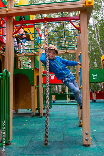 Fototapeta boy playing on the playground on a nice day