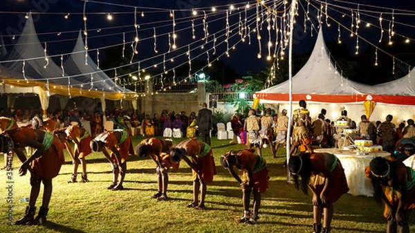 Obraz Kampala, Uganda - July 09, 2017: local performers in Uganda sing, dance and play traditional music at the wedding event, marriage ceremony in Kampala, culture and traditions in Uganda, local clothes