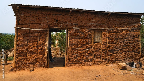 Obraz old local traditional house in Rwanda, made of animals' dung, clay and hay, poverty in Africa, primitive homes, real life in Eastern Africa, poor simple settlements in villages
