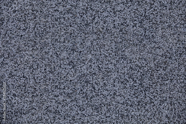 Fototapeta Close view of the wall with mosaic and granulated textured surface. Structural plaster, rough, uneven surface in grey color.