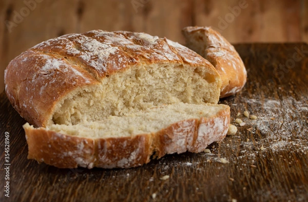 Fototapeta Sliced bread. Delicious, beautiful homemade bread. Bread on the table. Bread for the background.