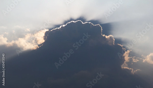 Obraz Surreal sun rays are striking through the clouds