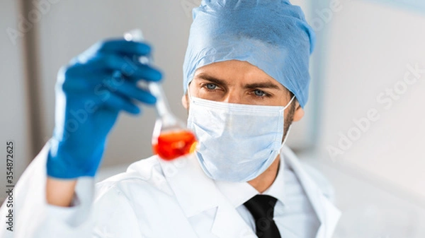 Fototapeta close up. medical flask in the hands of a laboratory assistant.