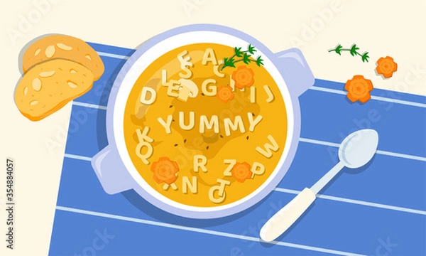 Fototapeta Tasty soup in a bowl with the addition of letters from pasta, greens and carrots, cooked by loving and creative parents