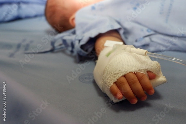 Obraz Children hand with saline solution in hospital.