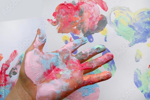 Fototapeta the imprint of a human hand with colorful paint and paint on the hand