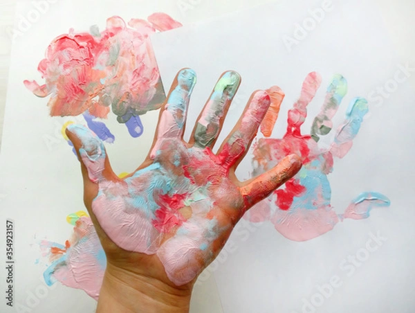 Fototapeta the imprint of a human hand with colorful paint and paint on the hand