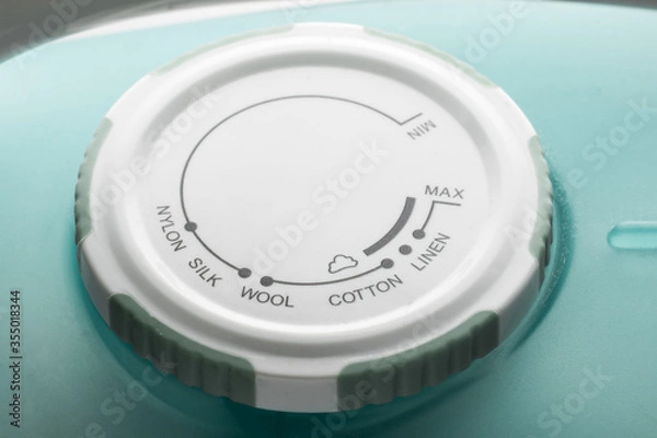 Fototapeta Round plastic rotary temperature controller and the choice of modes of ironing on an electric iron