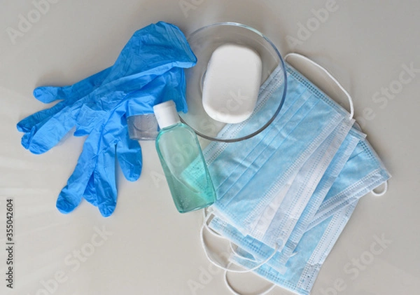Fototapeta Covid-19 prevention concept background, rubber gloves, hand sanitizer, surgical masks and antibacterial soap isolated on white background, medical backdrop