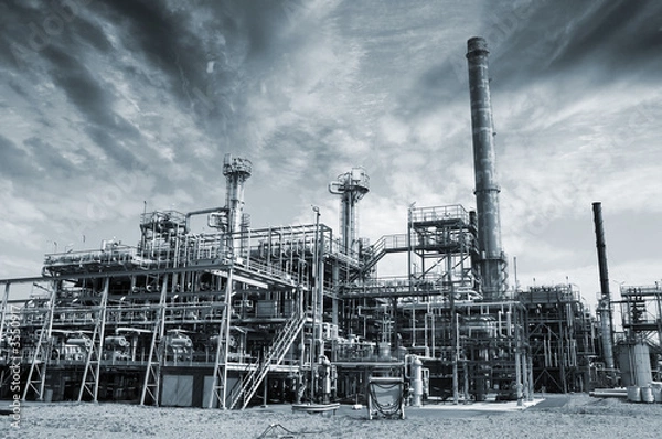 Fototapeta oil refinery with imposing dark clouds