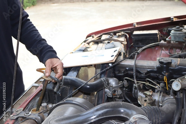 Fototapeta auto mechanic changing car engine