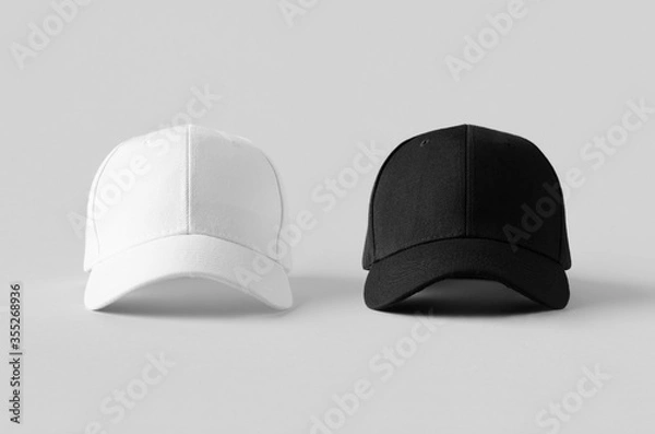 Fototapeta White and black baseball caps mockup on a grey background, front view.