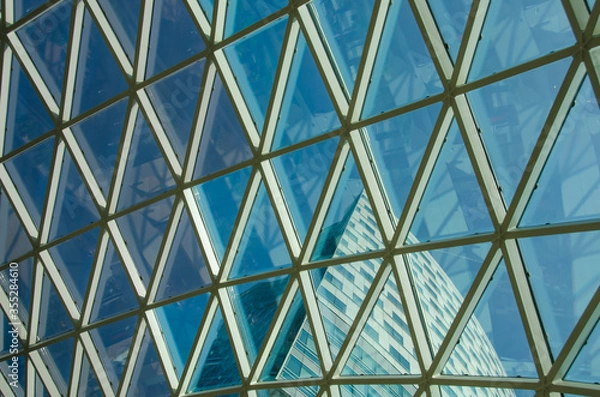 Obraz Glass windows grid on blue sky and building