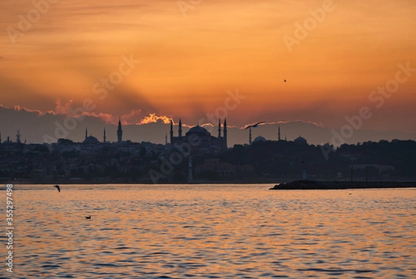Fototapeta Beautiful sunset in Istanbul, Turkey. Sun is setting down above Hagia Sophia. Sunset landscape panorama of Istanbul taken in July, in summer.