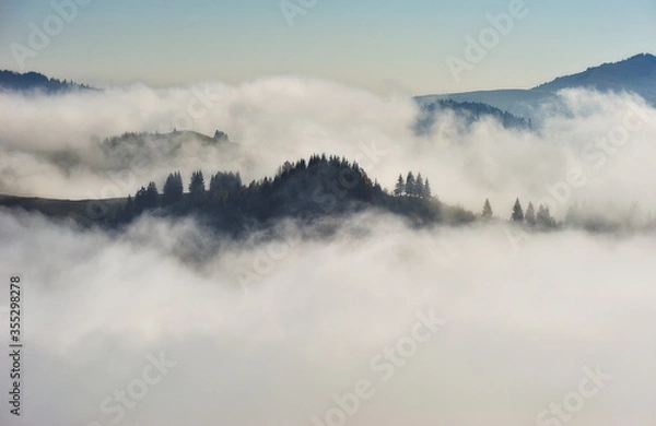 Fototapeta Predawn time in the highlands. mountain silhouettes in the fog