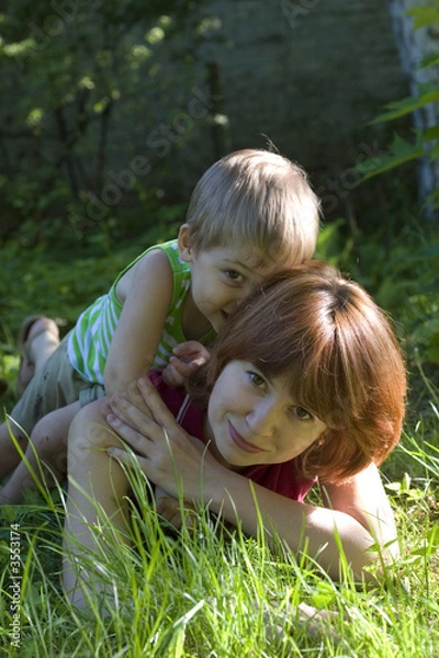 Fototapeta loving mother with her little cute son in the rays of sun