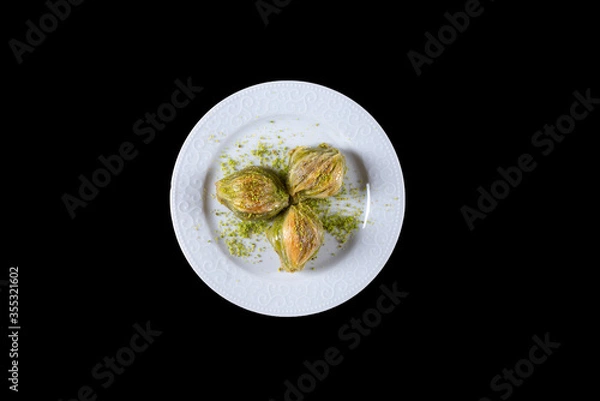 Fototapeta Pistachio baklava.  Traditional Dessert Baklava with pistachio. top view black background isolated