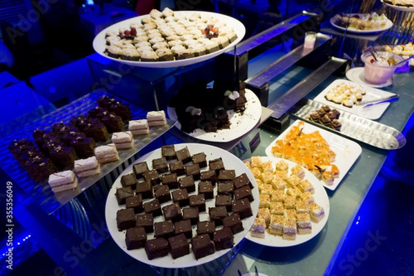 Fototapeta Close up view of assortment of fresh dessert captured from above with bokeh effect