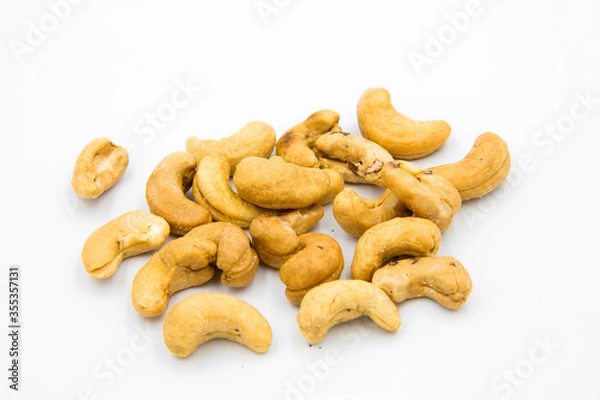 Obraz Some cashews were placed on a white ground.