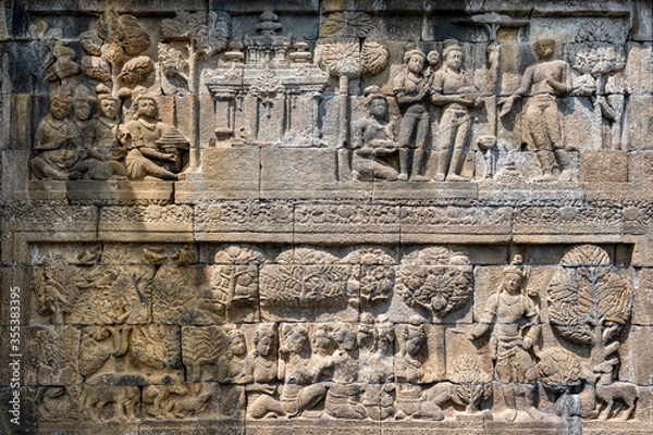 Fototapeta The stories from Mahayana Buddhist Sutras carved on the relief panels of Borobudur Temple (750AD)
