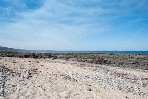 Fototapeta Empty Large Rocky Coastal Seaside Scene and Beach on a Sunny Day