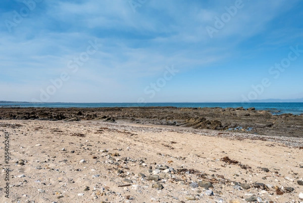Fototapeta Empty Large Rocky Coastal Seaside Scene and Beach on a Sunny Day