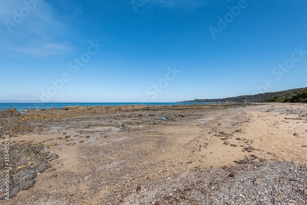 Fototapeta Empty Large Rocky Coastal Seaside Scene and Beach on a Sunny Day