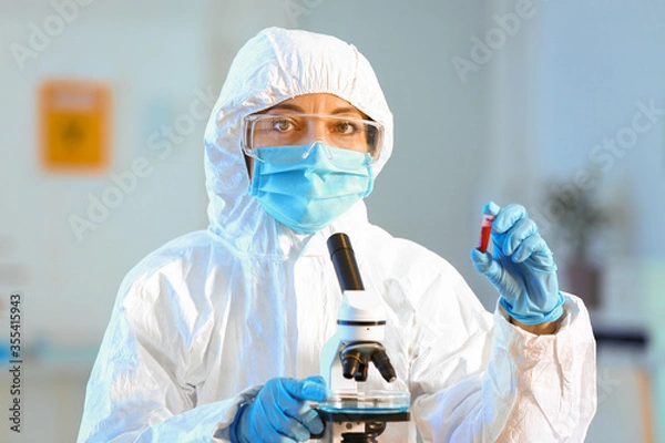 Fototapeta Scientist working with microscope in laboratory