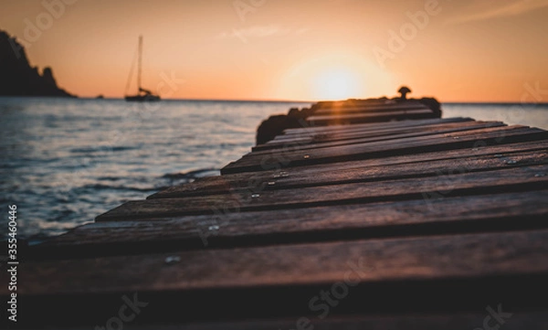 Fototapeta Wood bridge in the beach and sunset