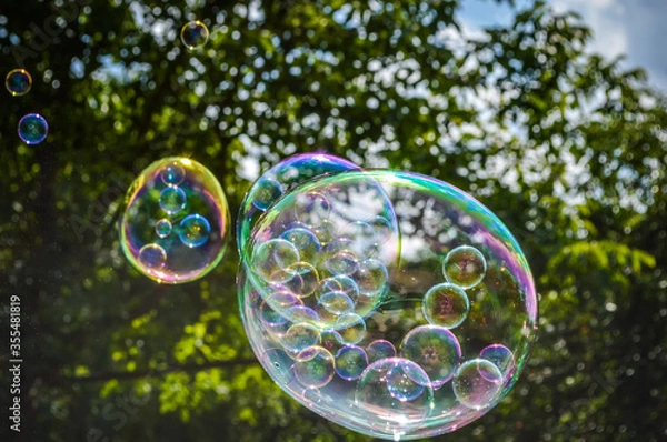 Obraz Soap bubble with smaller bubbles inside close up
