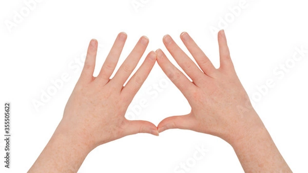 Obraz Freckled white hands,  making a diamond or kite frame between thumb and index finger with fingers splayed, palms down.  Female hand isolated