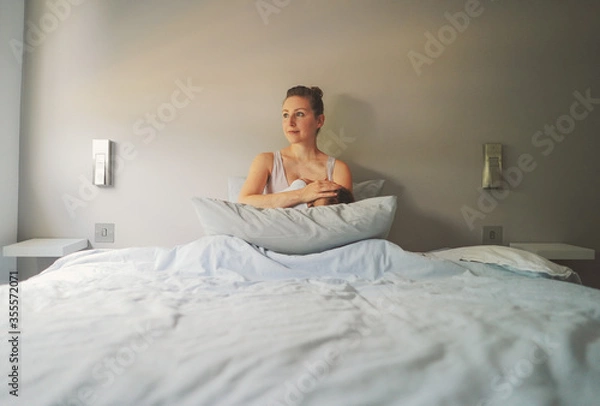 Obraz Maternity- mother and baby on the bed with grey background wall