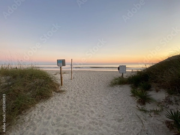 Fototapeta sunset on the beach sand path