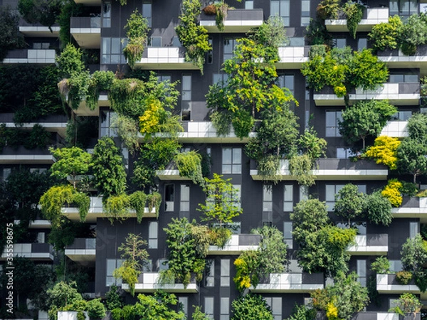 Fototapeta Milano, Italy. Bosco Verticale, a close up view at the modern and ecological skyscrapers with many trees on each balcony. Modern architecture, vertical gardens, terraces with plants