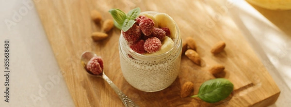 Fototapeta Vegan Chia Pudding with Frozen raspberry, Banana and almond on w