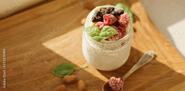 Fototapeta Vegan Chia Pudding with Frozen raspberry, Banana and almond on w