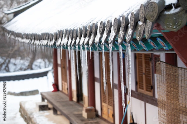 Fototapeta There are icicles on the roof.