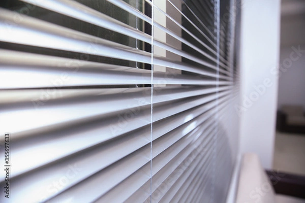 Fototapeta Office blinds. Modern wooden jalousie. Office meeting room lighting range control. venetian blinds by the window . Sunlight coming through venetian blinds by the window .