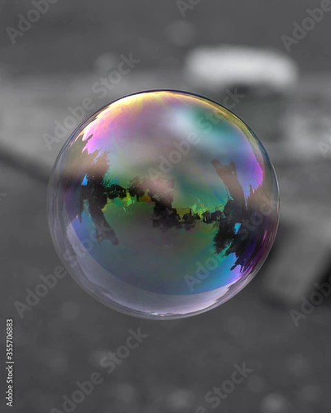 Obraz Rainbow iridescent soap bubble on plain background