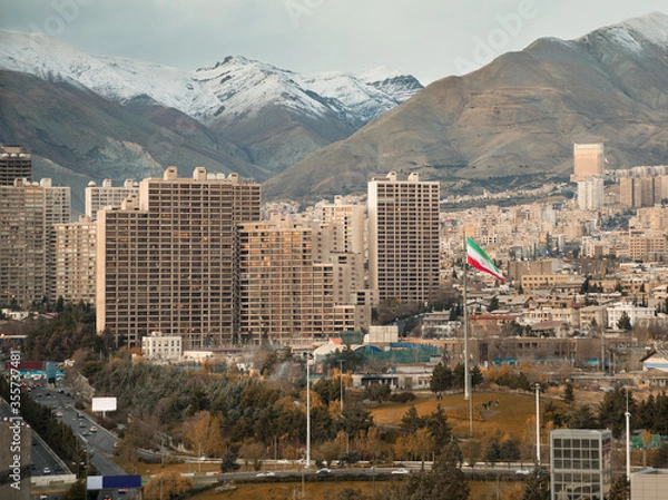 Fototapeta Large Iran Flag and Tehran City Skyline against Alborz Mountains with Instagram Warm Effect