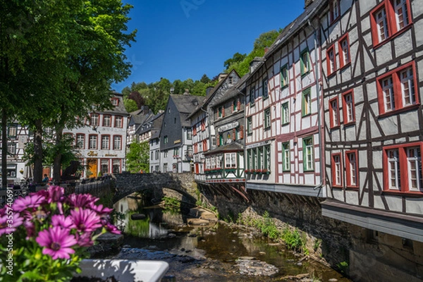 Fototapeta Monschau town in Germany street view with half-timbered houses and Rur river - a small resort town in the Eifel region of western Germany, located in the Aachen district of North Rhine-Westphalia 