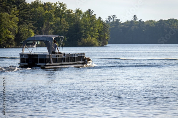 Fototapeta pontoon boat with canopy on lake